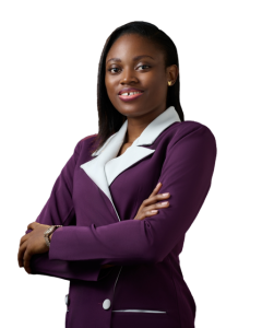 Picture of Jane OLUWADARE. She is wearing a purple jacket with white lapels, holding her arms crossed and smiling into the camera
